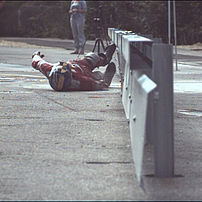 Impact test motorcyclist: HIII 50% dummy before impact to an underride protection on a rammed steel safety barrier