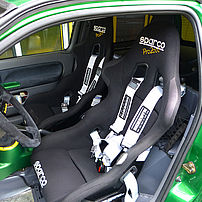 Individual vehicle with sports seats, harness seatbelts and a sports steering wheel